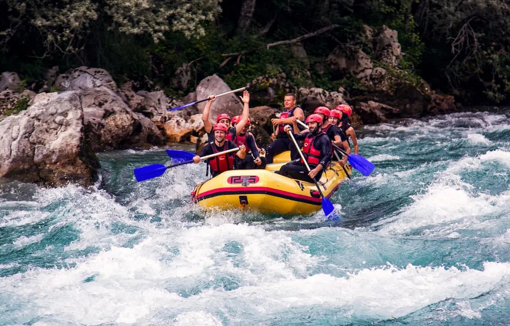 visitors doing river rafting in river around Pacifc inn - best riverside resort in rishikesh